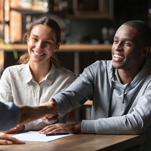 Couple Shaking Hands With Loan Officer